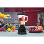 Woman,Making,Green,Smoothie,On,The,Kitchen.,Focus,On,The