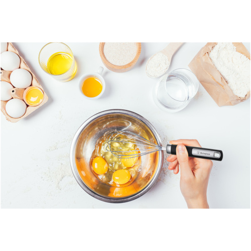 Female,Hand,Holding,Whisk,Mixes,Eggs,In,Metal,Bowl,Next